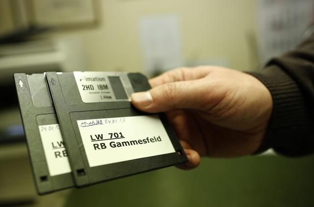 Peter Breiter, CEO of Raiffeisen Gammesfeld eG bank, displays the latest floppy disks at the bank in Gammesfeld, Baden-Wuerttemberg January 29, 2013. The Raiffeisen Gammesfeld eG cooperative bank is one of the country's smallest banks and is the only one to be run by just one member of staff. All banking duties are done by CEO Peter Breiter who records the daily business by hand, partly on paper. The bank is not connected to a database system, there are no automatic teller machines (ATMs) and its customer base consists only of residents of the town of Gammesfeld which has a population of around 510. Picture taken January 29, 2013. REUTERS/Lisi Niesner  (GERMANY - Tags: BUSINESS SOCIETY)

ATTENTION EDITORS: PICTURE 15 OF 26 FOR PACKAGE 'GERMANY'S ONE MAN BANK'. 
TO FIND ALL IMAGES SEARCH 'Raiffeisen'