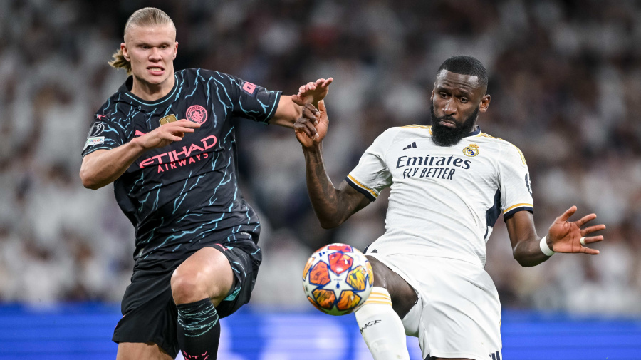 Getty Images - MADRID, SPAIN - APRIL 9: Erling Haaland of Manchester City and Antonio Ruediger of Real Madrid CF battle for the ball during the UEFA Champions League quarter-final first leg match between Real Madrid CF and Manchester City at Estadio Santiago Bernabeu on April 9, 2024 in Madrid, Spain. (Photo by Harry Langer/DeFodi Images via Getty Images)