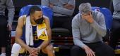 Golden State Warriors guard Stephen Curry, left, sits next to assistant coach Bruce Fraser. (AP)