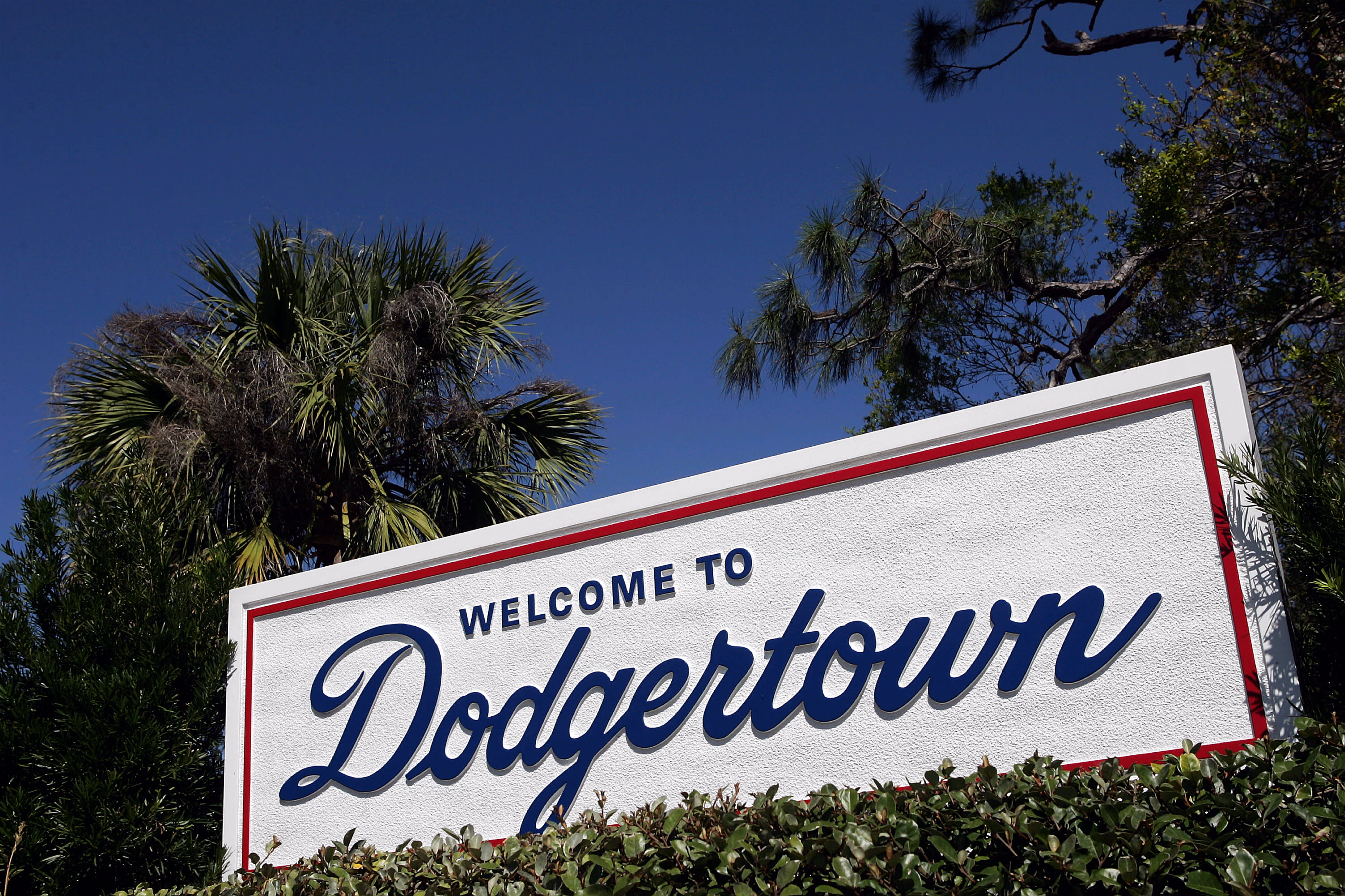 Dodgers fans greet Astros team bus with trash cans and signs following cheating scandal