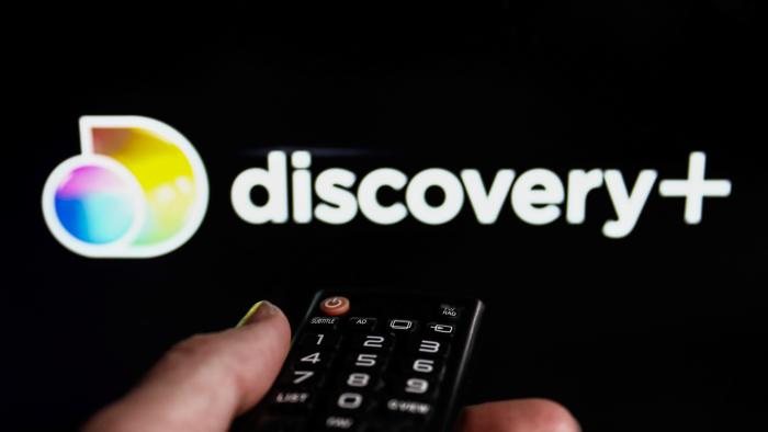 TV remote control and Discovery+ logo displayed on a laptop screen are seen in this illustration photo taken in Krakow, Poland on February 9, 2022. (Photo illustration by Jakub Porzycki/NurPhoto via Getty Images)