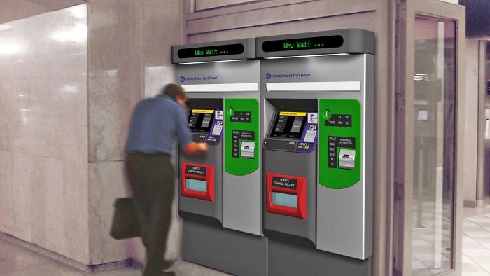 An MTA MetroCard vending machine in use at a train station. One man is using one of the two machines there.