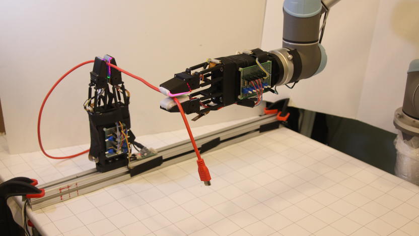 A picture of MIT's new robot handling a USB cable.