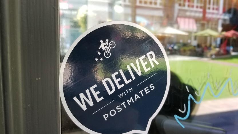 Close-up of logo reading We Deliver With Postmates, referencing the Postmates food delivery app service, on a restaurant window in the Silicon Valley, San Jose, California, June 7, 2018. (Photo by Smith Collection/Gado/Getty Images)