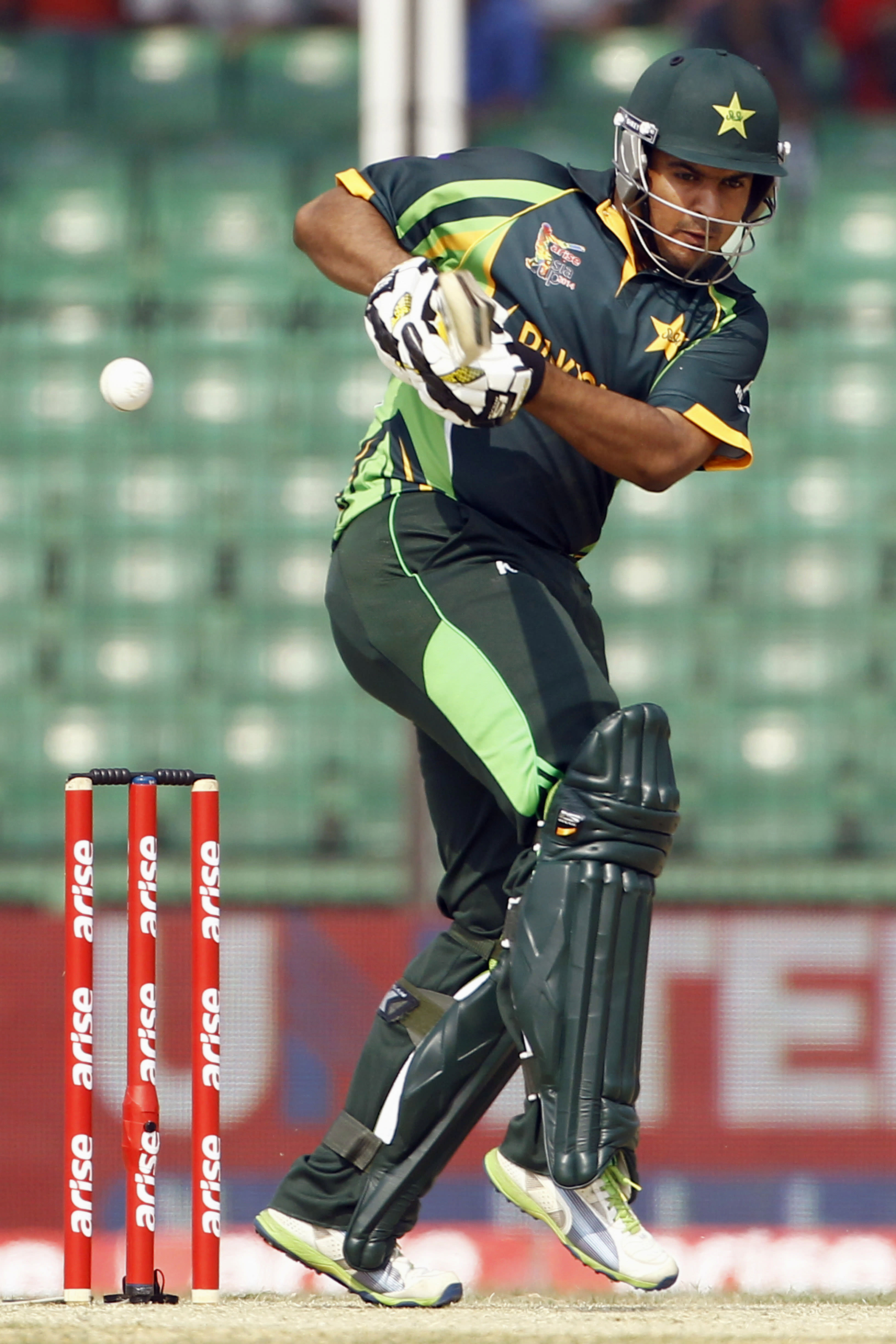 Akmal century guides Pakistan to 2488