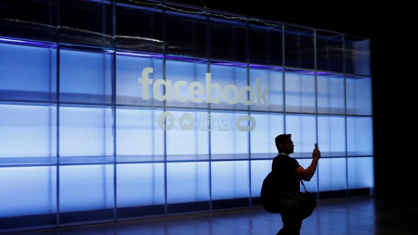 An attendee takes a photograph of a sign during Facebook Inc's F8 developers conference in San Jose, California, U.S., April 30, 2019.  REUTERS/Stephen Lam