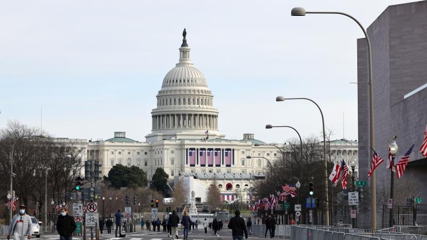 WASHINGTON, DC - JANUARY 16: Pedestrians walk along Pennsylvania Avenue near the U.S. Capitol on January 16, 2021 in Washington, DC. After last week's riots at the U.S. Capitol Building, the FBI has warned of additional threats in the nation's capital and in all 50 states. According to reports, as many as 25,000 National Guard soldiers will be guarding the city as preparations are made for the inauguration of Joe Biden as the 46th U.S. President. (Photo by Michael M. Santiago/Getty Images)