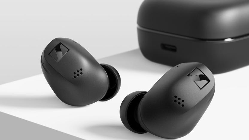 Sennheiser Accentum True Wireless earbuds in black sitting on a white surface with the charging case in the background.