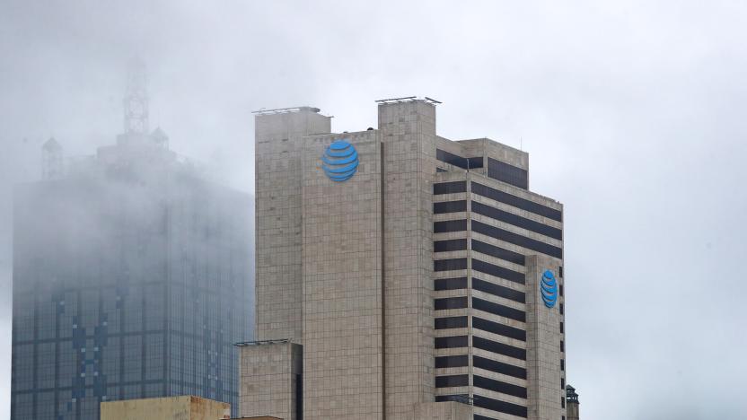 An AT&T office high-rise building on an overcast day with clouds surrounding the top floors.