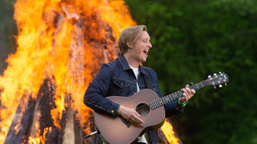 GLASTONBURY, UNITED KINGDOM - MAY 22: In this image released on May 22nd 2021, George Ezra performs by a fire as part of the Glastonbury Festival Global Livestream “Live at Worthy Farm” at Worthy Farm, Pilton on May 21, 2021 in Glastonbury, England. The five hour special production has been filmed across Glastonbury Festivals Worthy Farm site with artists including Coldplay, Damon Albarn, HAIM, IDLES, Jorja Smith, Kano, Michael Kiwanuka, Wolf Alice and DJ Honey Dijon with Roisin Murphy. The global livestream is being broadcast today, Saturday May 22, with encore screenings tomorrow, Sunday May 23. (Anna Barclay for Glastonbury Festival via Getty Images)