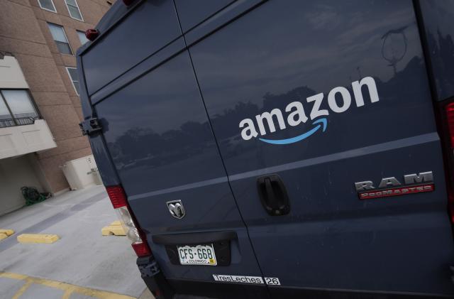 The company logo graces one of the doors of a delivery van for Amazon Wednesday, Sept. 1, 2021, in Denver. A labor organizer says more than 60 Amazon workers across three delivery stations staged a walkout on Wednesday, March 16, 2022, to demand a $3 raise and a return to 20-minute breaks. (AP Photo/David Zalubowski)