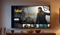 TV mounted on a wall, showing Amazon Prime TV's new layout. Screen shows details for Fallout.