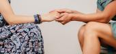 Sister's hold hands. (Getty Images)