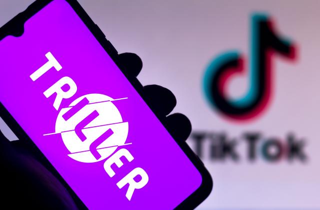 BRAZIL - 2020/08/17: In this photo illustration the Triller logo seen displayed on a smartphone with a TikTok logo in the background. (Photo Illustration by Rafael Henrique/SOPA Images/LightRocket via Getty Images)