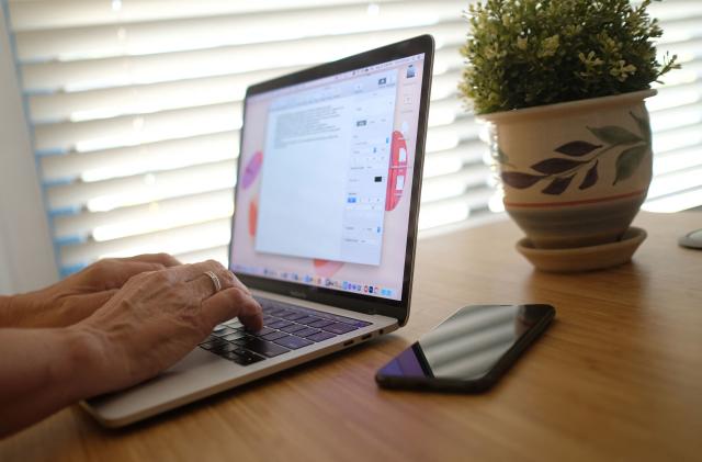 This illustration photo shows a person working on their laptop from a home office in Los Angeles on August 13, 2021. - In the United States, companies are delaying one after another the return of their employees to the office, worried about the new wave of contaminations with the spread of the Delta variant. (Photo by Chris DELMAS / AFP) (Photo by CHRIS DELMAS/AFP via Getty Images)