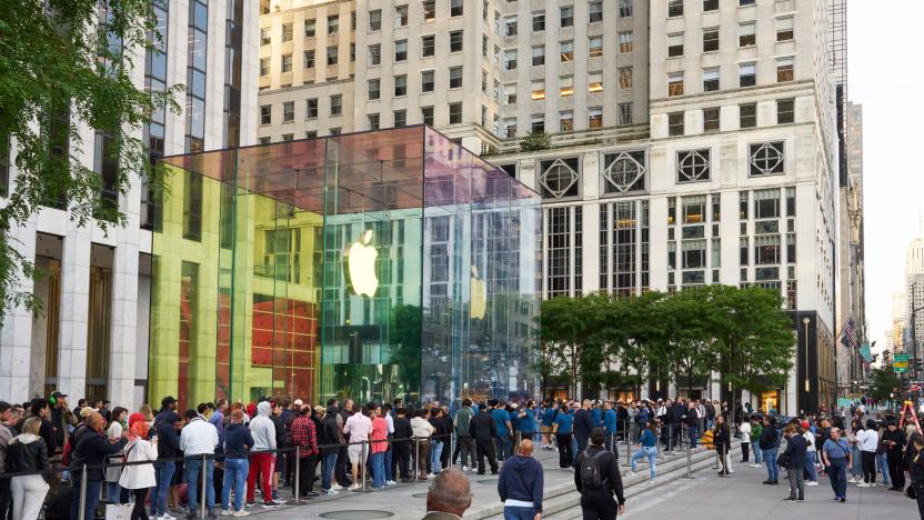 A square structure made of glass with the Apple logo.