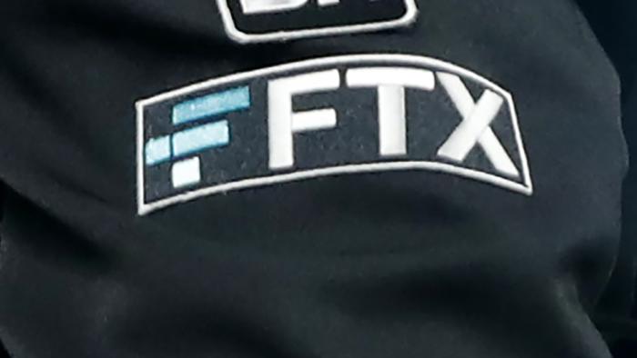 FILE - The FTX logo appears on home plate umpire Jansen Visconti's jacket at a baseball game with the Minnesota Twins on Sept. 27, 2022, in Minneapolis. Failed cryptocurrency exchange FTX says that nearly all of its customers will receive the money back that they are owed, and some will get more than that, according to its reorganization plan. FTX said in a court filing Tuesday, May 7, 2024 that it owes about $11.2 billion to its creditors. (AP Photo/Bruce Kluckhohn, File)