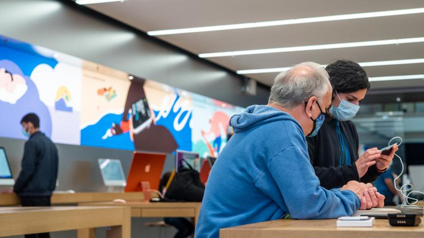 HOUSTON, TEXAS - FEBRUARY 18: An Apple Store employee provides service to a customer at an Apple Store on February 18, 2022 in Houston, Texas. According to a recent report, Apple Store employees around the United States are planning to unionize, calling for an increase in pay rates to keep up with inflation.  (Photo by Brandon Bell/Getty Images)