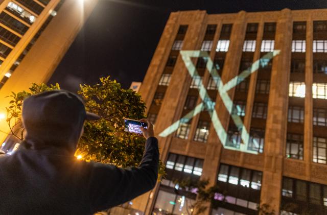 Twitter's new logo is seen projected on the corporate headquarters building in downtown San Francisco, California, U.S. July 23, 2023. REUTERS/Carlos Barria