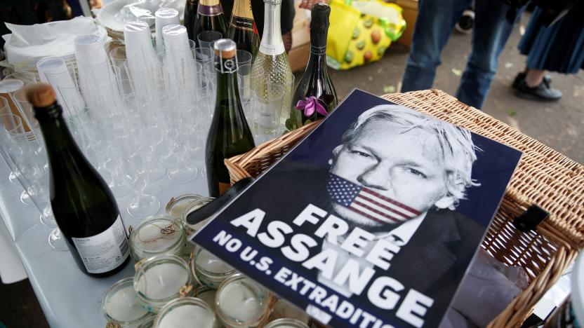 A view shows a placard depicting WikiLeaks founder Julian Assange, near bottles of sparkling wine belonging to his supporters, on the day of his and Stella Moris' wedding at HMP Belmarsh prison, in London, Britain, March 23, 2022. REUTERS/Peter Nicholls
