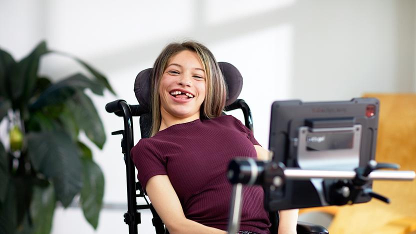 A Tobii Dynavox's user with a TD Pilot attached to her wheelchair.