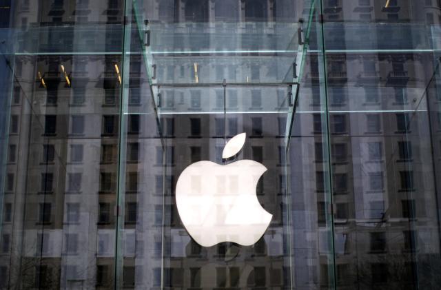 The Apple logo hangs inside the glass entrance to the Apple Store on 5th Avenue in New York City, April 4, 2013.  REUTERS/Mike Segar    (UNTIED STATES - Tags: BUSINESS SCIENCE TECHNOLOGY TELECOMS)