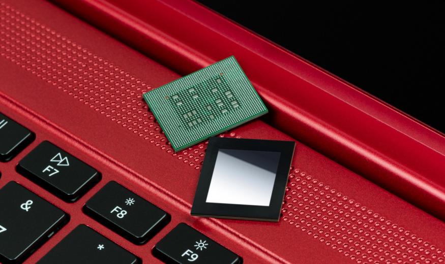 Qualcomm Snapdragon 8cx Gen 3 chipset on top of a red laptop.