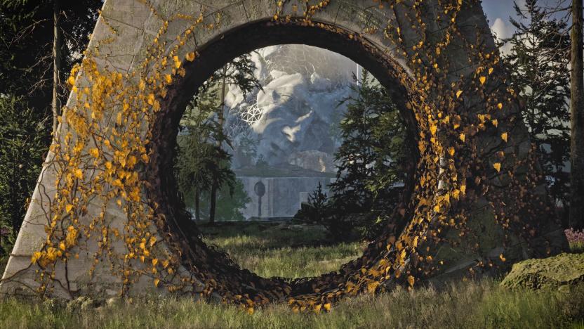 A still from the video game The Talos Principle 2 showing a large triangluar stone pillar with a hold cut in its base. We see a large sculpture of a face in the distance through it.