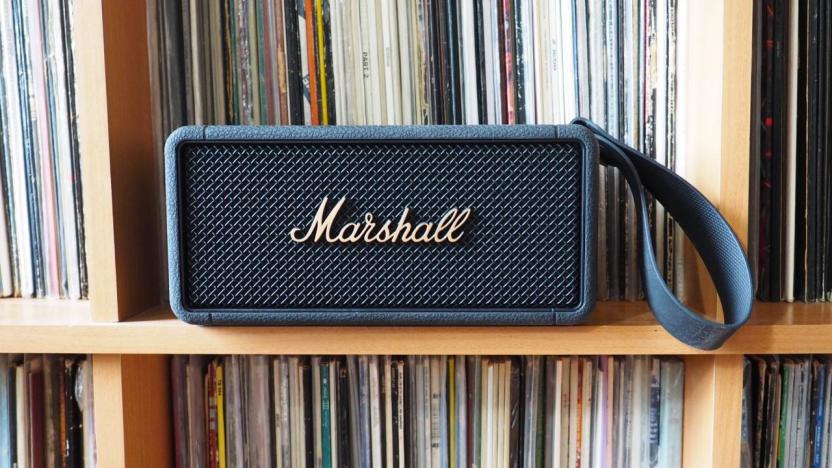 The Marshall Middleton Bluetooth speaker sits on a shelf with many many LPs. 
