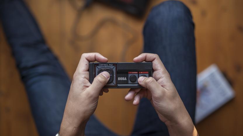 Gothenburg, Sweden - January 07, 2015: A shot from above of a young mans hands holding an old game pad for the Sega Master System. Natural lights.