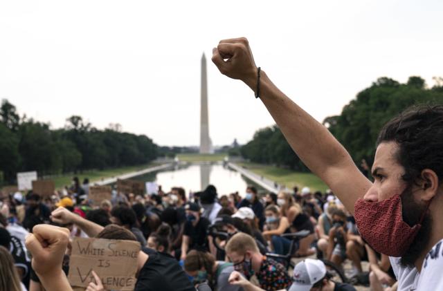 WASHINGTON, DC - JUNE 04: Demonstrators take a knee as at the base of the Lincoln Memorial as they peacefully protest against police brutality and the death of George Floyd, on June 4, 2020 in Washington, DC. Protests in cities throughout the country have been largely peaceful following the death of George Floyd, a black man who was killed in police custody in Minneapolis on May 25. (Photo by Drew Angerer/Getty Images)