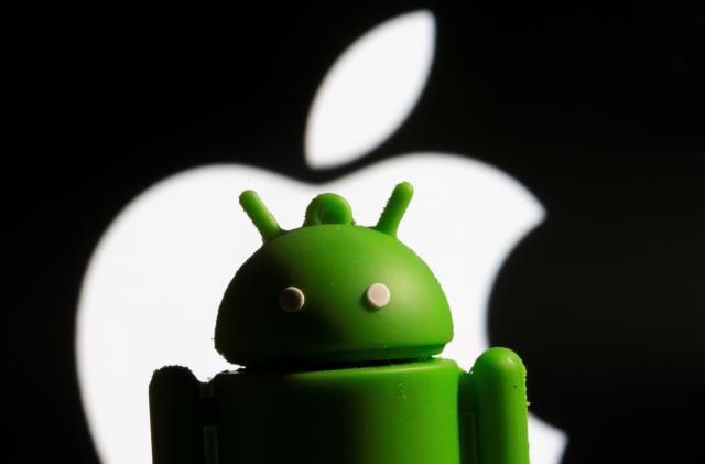 A 3D printed Android mascot Bugdroid is seen in front of the Apple logo in this illustration taken November 3, 2021. REUTERS/Dado Ruvic/Illustration