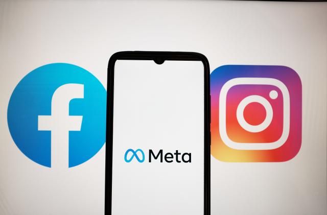 In this photo illustration a Meta logo seen displayed on a smartphone screen with Facebook and Instagram logos on a MacBook screen in Athens, Greece on April 28, 2023. (Photo illustration by Nikolas Kokovlis/NurPhoto via Getty Images)