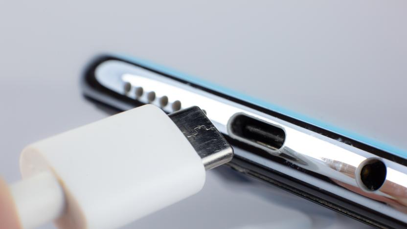 Man connecting USB Type C Port Cable for charging to the smartphone. Close up photo.