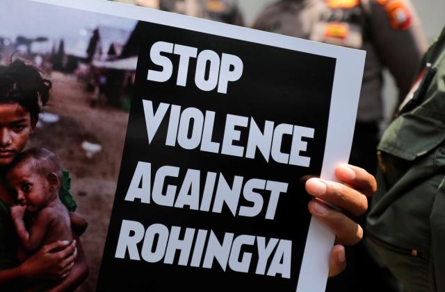 A protester holds a placard during protest against Myanmar's treatment of its Rohingya Muslim minority in front of Myanmar's embassy in Jakarta, Indonesia, December 5, 2018. REUTERS/Beawiharta