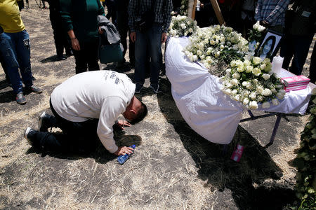 Image result for images of Ethiopian crashed plane grief-stricken relatives paying their respects.