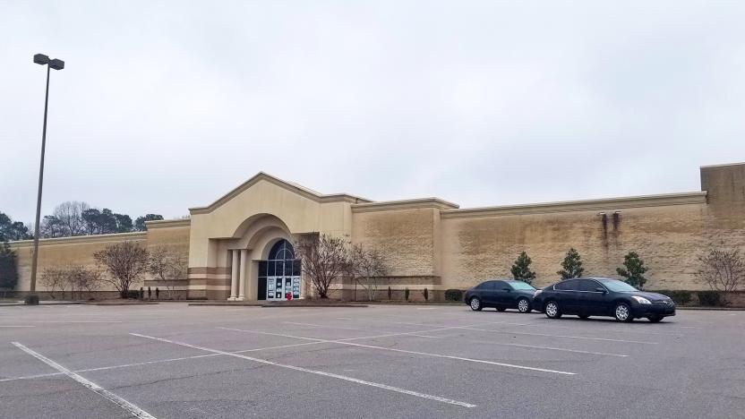 A mostly empty shopping mall parking lot and the building that will soon house Epic Games offices.