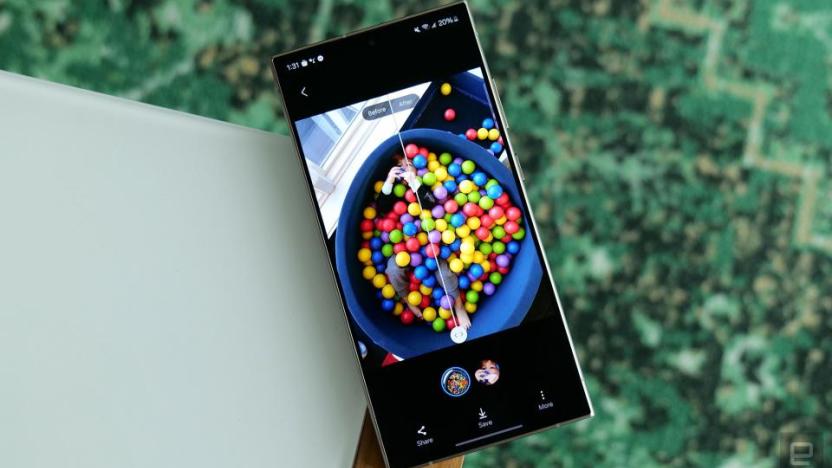 Photo of the Galaxy S24’s AI-based photo editing feature on the Galaxy S24 Ultra. A colorful ball pit is viewed in split screen before and after edits. The phone sits on the corner of a table.