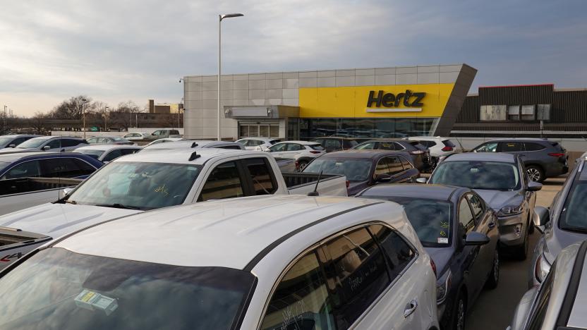 Cars are parked near Hertz car rental signage at John F. Kennedy International Airport in Queens, New York City, U.S., March 30, 2022. REUTERS/Andrew Kelly