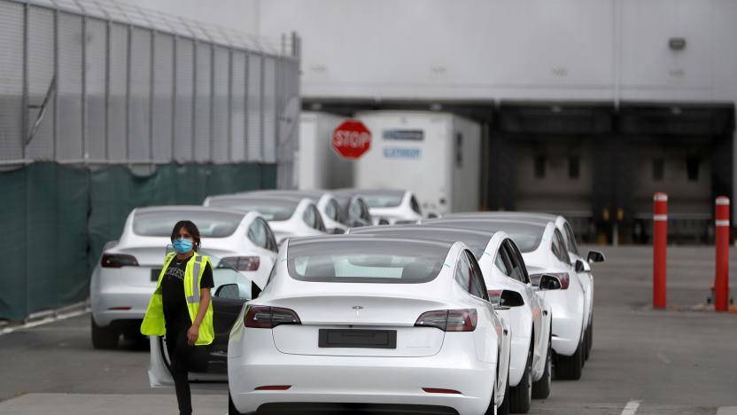 A worker exits a Tesla Model 3 electric vehicle at Tesla's primary vehicle factory after CEO Elon Musk announced he was defying local officials' coronavirus disease (COVID-19) restrictions by reopening the plant in Fremont, California, U.S. May 11, 2020. REUTERS/Stephen Lam     TPX IMAGES OF THE DAY
