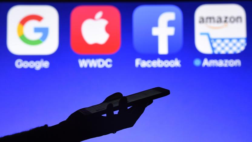 This photograph taken on September 28, 2017, shows a smartphone being operated in front of GAFA logos (acronym for Google, Apple, Facebook and Amazon web giants) as background in Hédé-Bazouges, western France. / AFP PHOTO / Damien MEYER        (Photo credit should read DAMIEN MEYER/AFP/Getty Images)