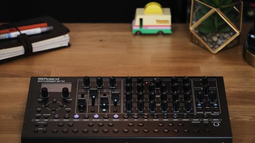 Roland SH-4d on a desk with a fake plant, a tiny wooden taco truck and a faux Travelers Notebook.