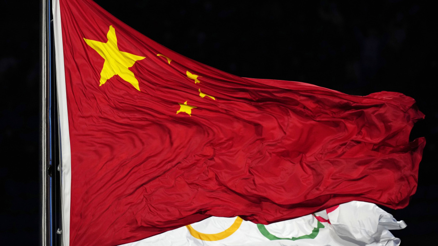 Associated Press - FILE - The Chinese and the Olympic flag wave during the opening ceremony of the 2022 Winter Olympics, Feb. 4, 2022, in Beijing. In the two years before the World Anti-Doping Agency cleared 23 Chinese swimmers of doping allegations, that country’s government contributed nearly $2 million in additional funding to WADA programs, including one designed to strengthen the agency’s investigations and intelligence unit. (AP Photo/Petr David Josek, file)