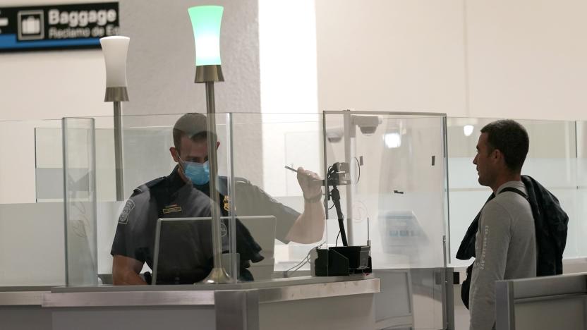 International passengers arrive at Miami international Airport where they are screened by U.S. Customs and Border Protection (CBP) using facial biometrics to automate manual document checks required for admission into the U.S. Friday, Nov. 20, 2020, in Miami. Miami International Airport is the latest airport to provide Simplified Arrival airport-wide. (AP Photo/Lynne Sladky)