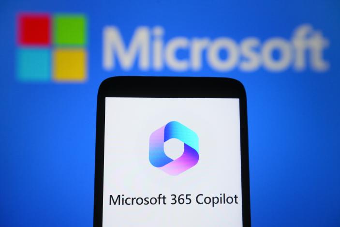 UKRAINE - 2023/03/17: In this photo illustration, a Microsoft 365 Copilot logo is seen on a smartphone and Microsoft logo on the background. (Photo Illustration by Pavlo Gonchar/SOPA Images/LightRocket via Getty Images)