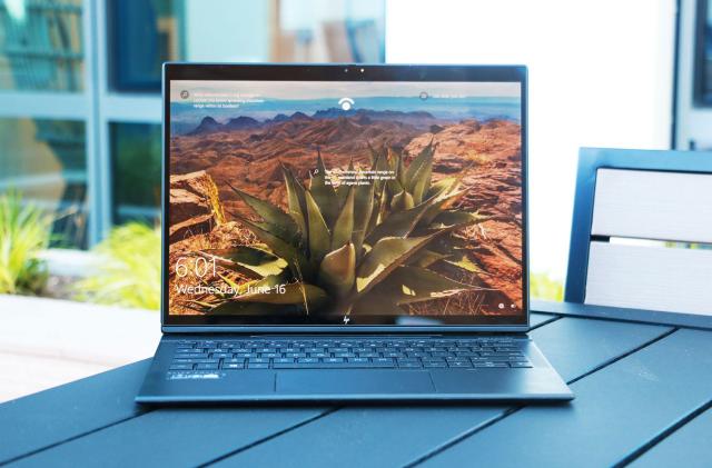 The HP Elite Folio laptop on a patio table.