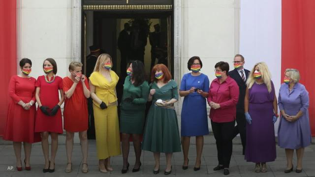 Lawmakers protest Polish president's anti-LGBTQ views by forming rainbow with their outfits at his swearing-in