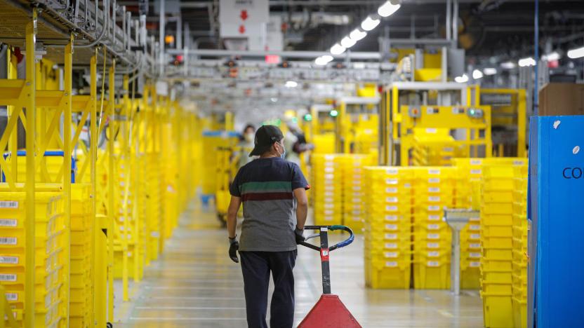 An employee pulls a cart at Amazon's JFK8 distribution center in Staten Island, New York, U.S. November 25, 2020.  REUTERS/Brendan McDermid.
