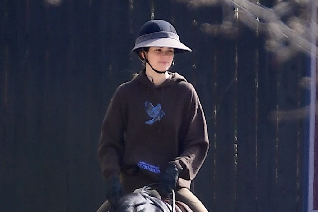 Kendall Jenner rides a horse with a monochrome equestrian appearance and high boots