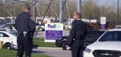 Police stand near the scene where multiple people were shot at the FedEx Ground facility early Friday morning. (AP)